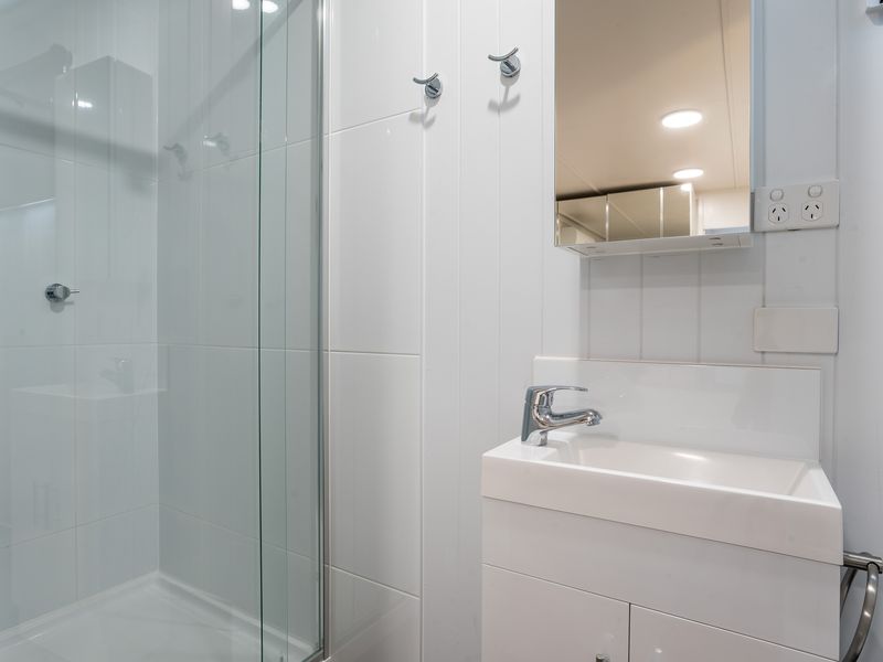 Compact bathroom with sink and storage cabinet