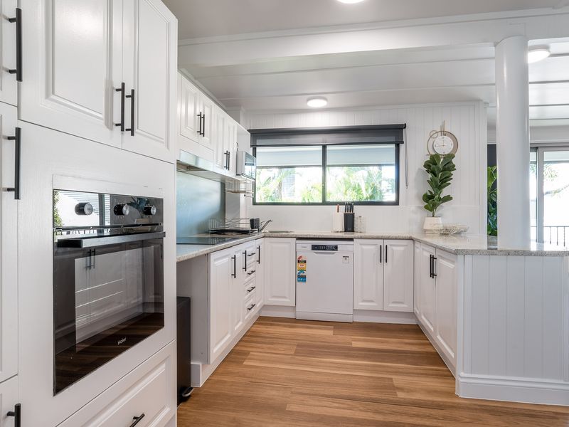 Contemporary kitchen with oven, dishwasher, and sleek cabinetry