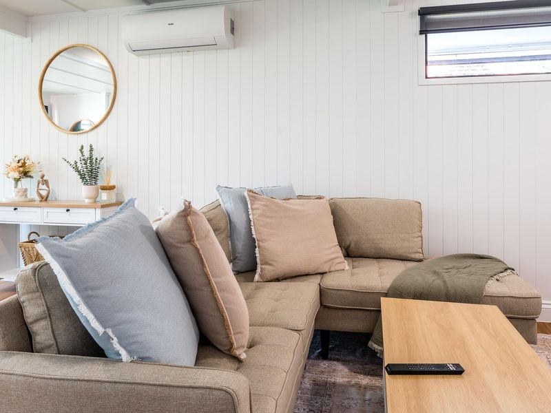 Modern lounge area with neutral tones and cozy seating