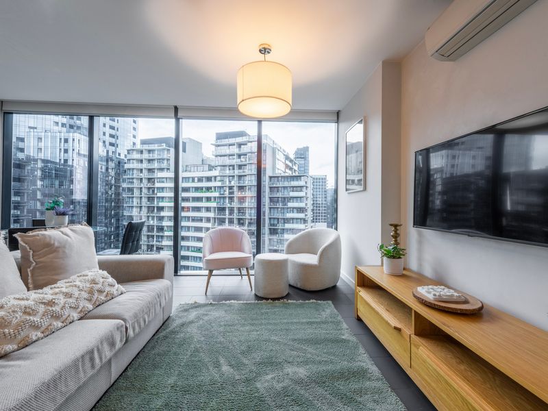 Stylish lounge area with flat-screen TV and city backdrop