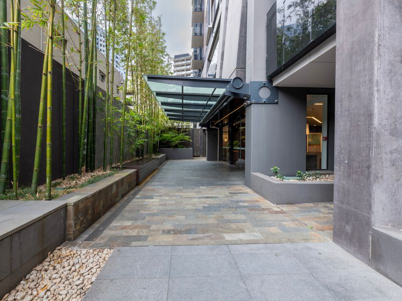 Modern building entrance with landscaped walkway