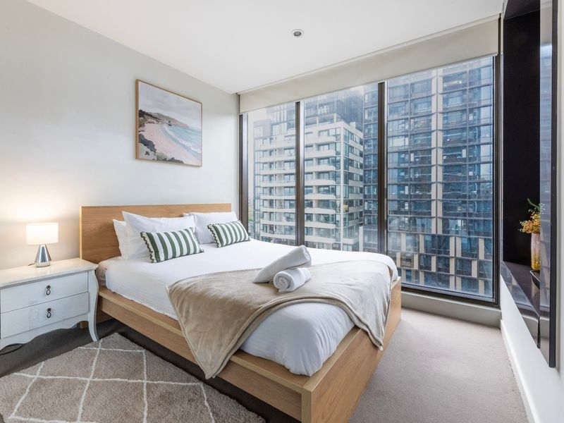 Cozy bedroom with double bed and city views