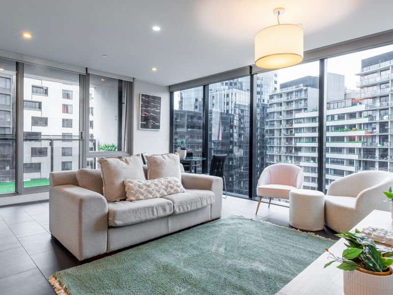 Bright and spacious living room with large windows and city views