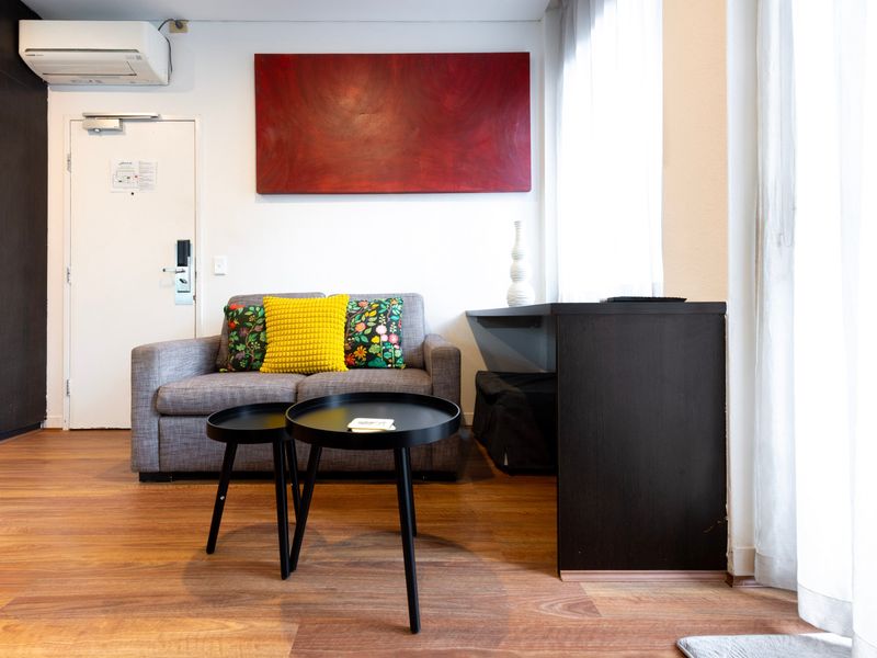 Living space with sofa, coffee table, and wall art near the entryway