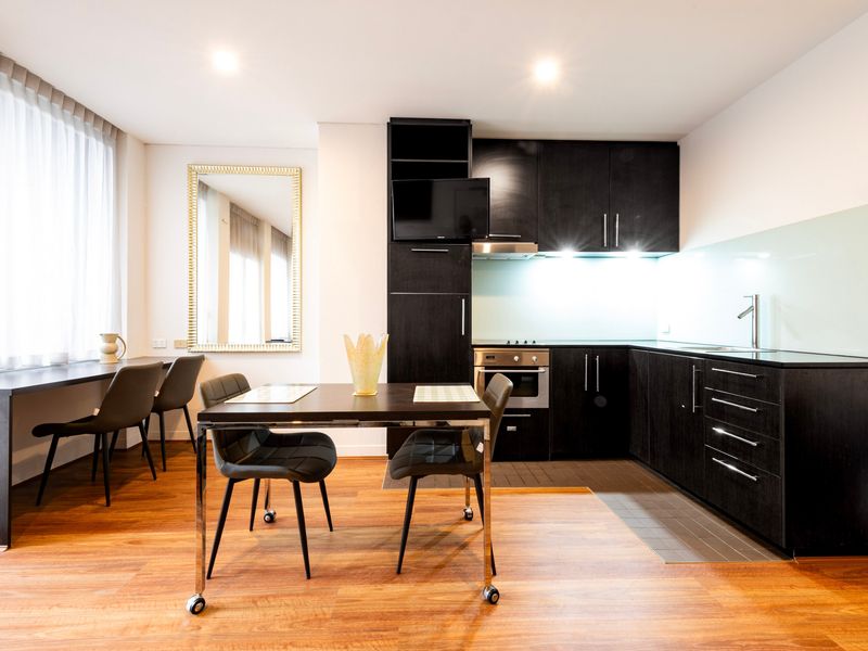 Open-plan dining area and kitchen with wooden flooring