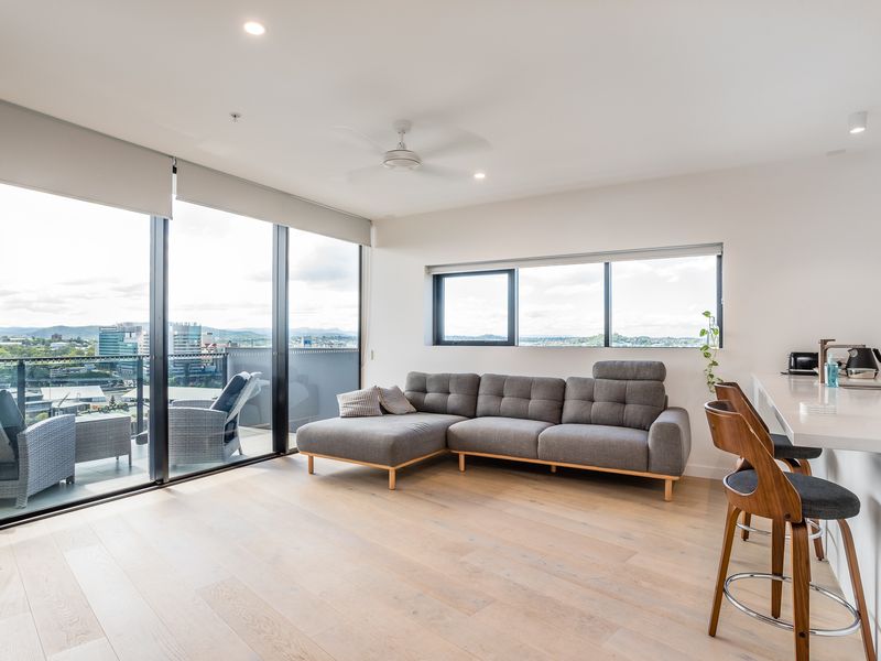 Open-plan living with high ceilings and floor-to-ceiling windows