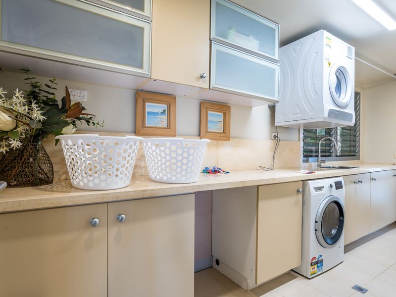 Laundry area with washer, dryer, and storage