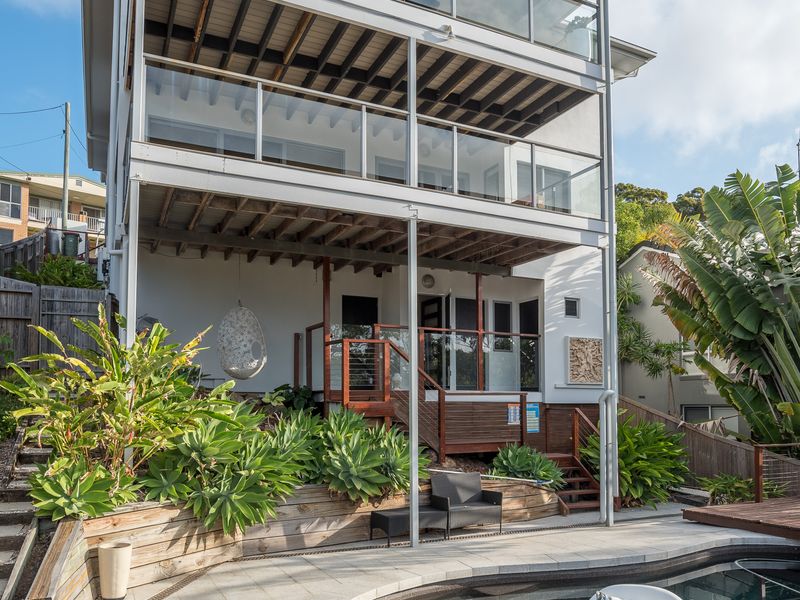 Rear view of the home and pool deck