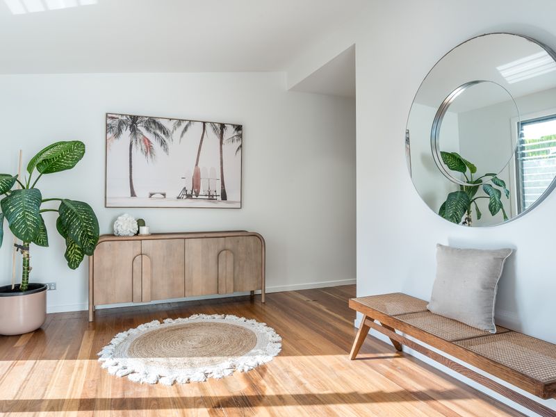 Welcoming entry with greenery and mirror decor