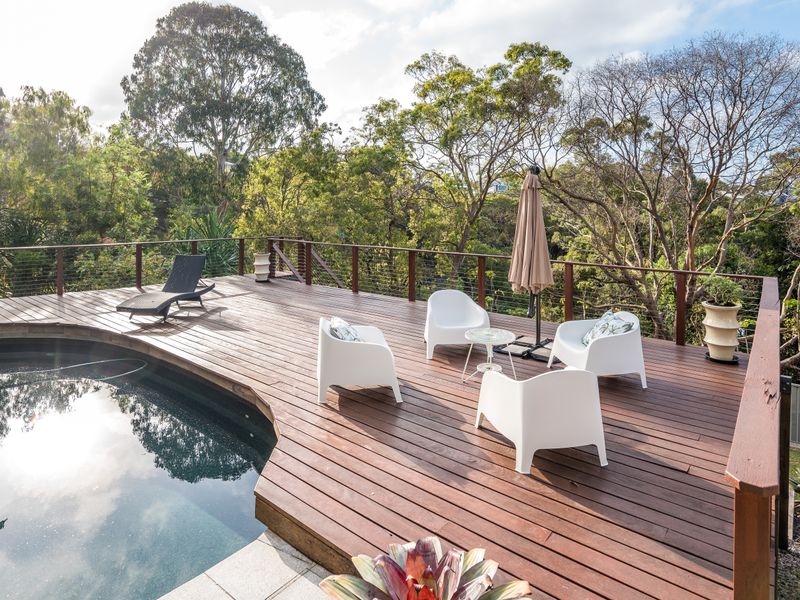 Private pool deck surrounded by native trees