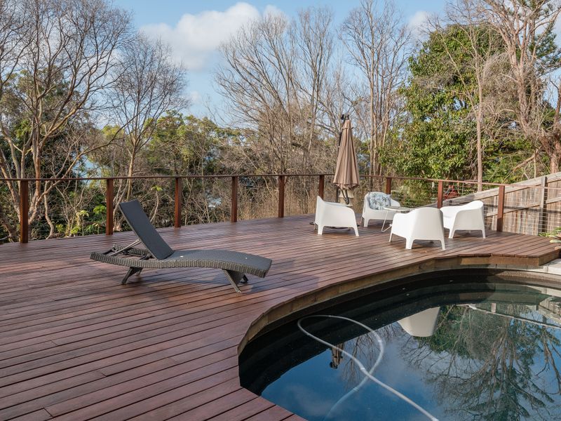 Timber deck with loungers and forest view
