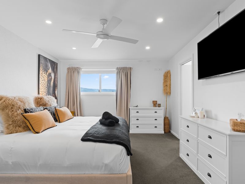 Comfortable bedroom with TV and storage