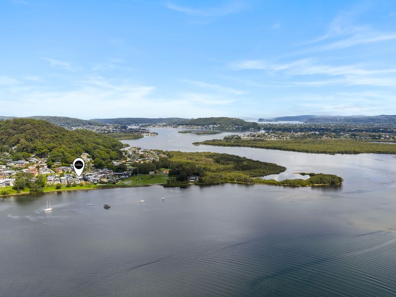 Stunning aerial view of the tranquil waterfront, showcasing the lush green hills and serene waters surrounding the town.