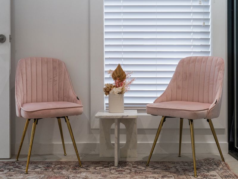 Stylish seating nook with plush chairs, ideal for a morning coffee or evening relaxation.