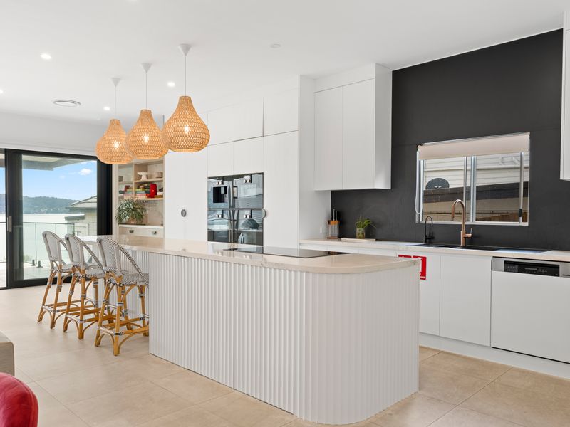 Sleek modern kitchen with high-end finishes and a breakfast bar perfect for casual dining