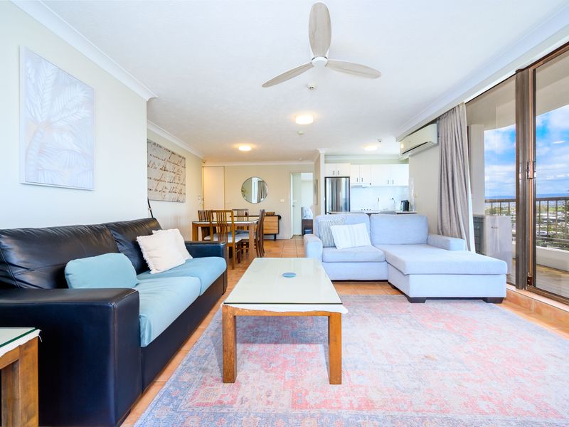 Spacious open-plan living room with balcony access