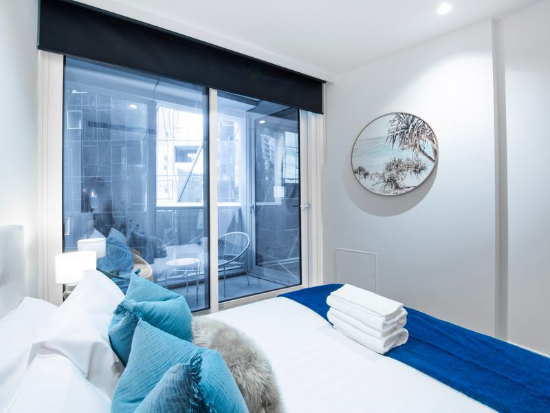 Spacious bedroom with natural light and city views