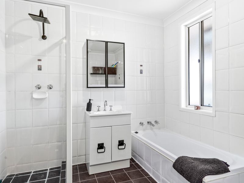 Clean, modern bathroom featuring a bathtub and walk-in shower