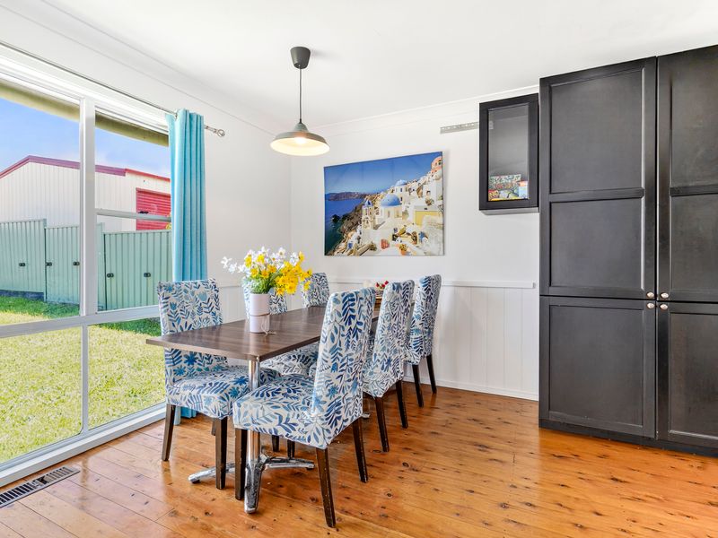 Sunny dining area with large windows overlooking the backyard
