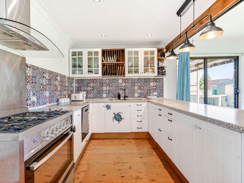 Fully equipped kitchen with modern appliances and ample bench space