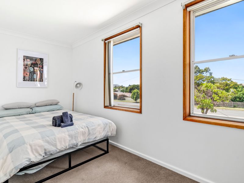 Comfortable bedroom with a soft queen bed and garden views