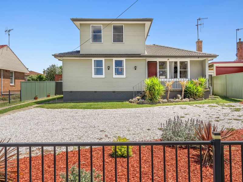 Charming front exterior with plenty of parking space