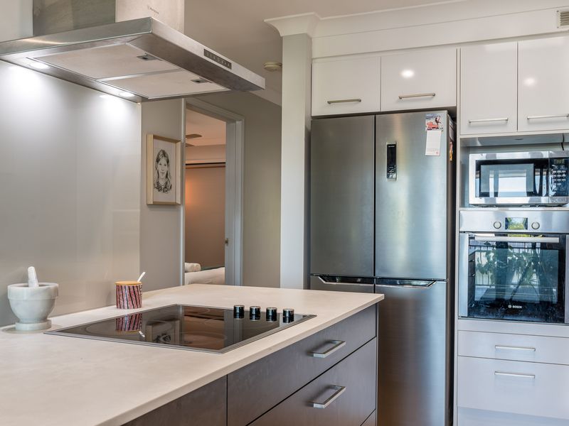 Kitchen island and cooking zone with built-in oven and fridge
