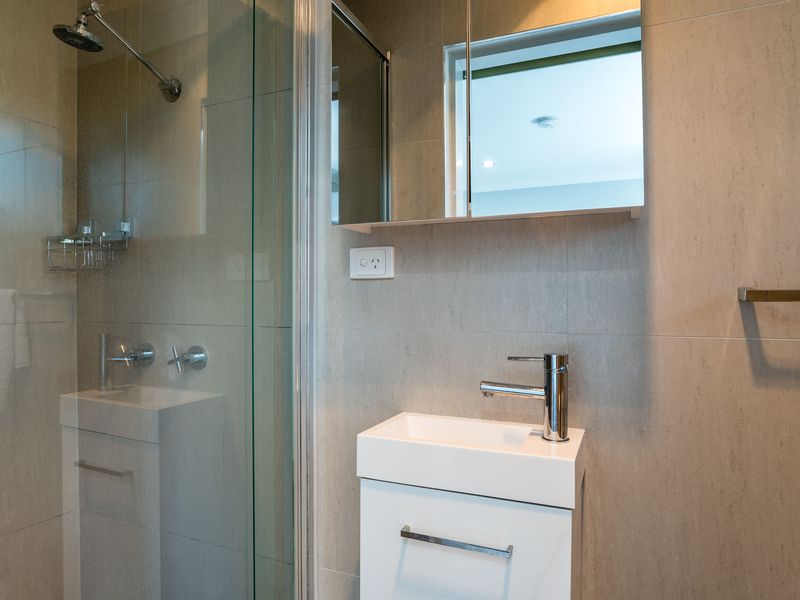 Modern bathroom vanity with walk-in shower and sleek finishes