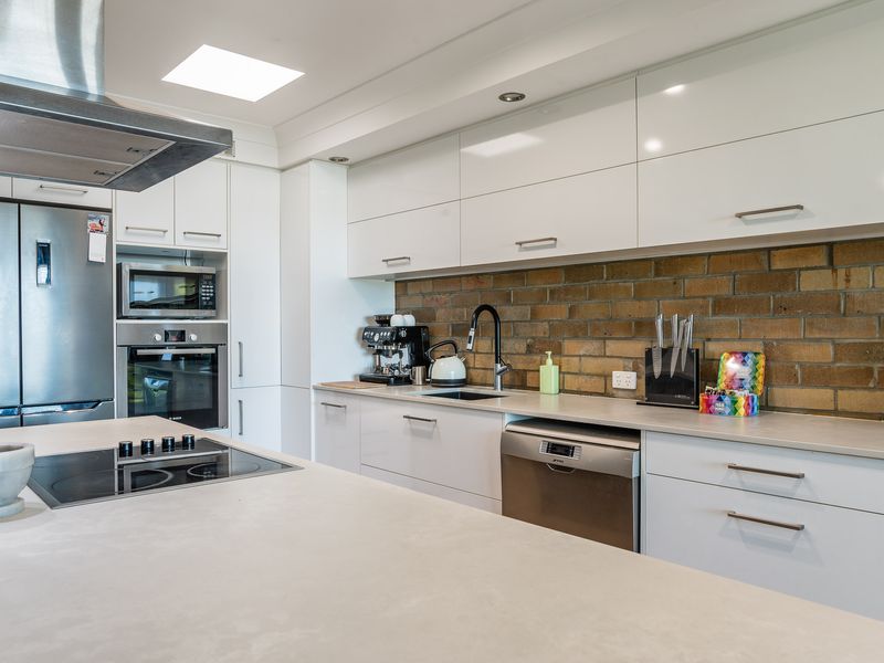 Spacious kitchen with stainless steel appliances and ample storage