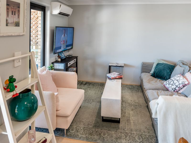 Alternate angle of the living space showing generous seating and indoor-outdoor flow