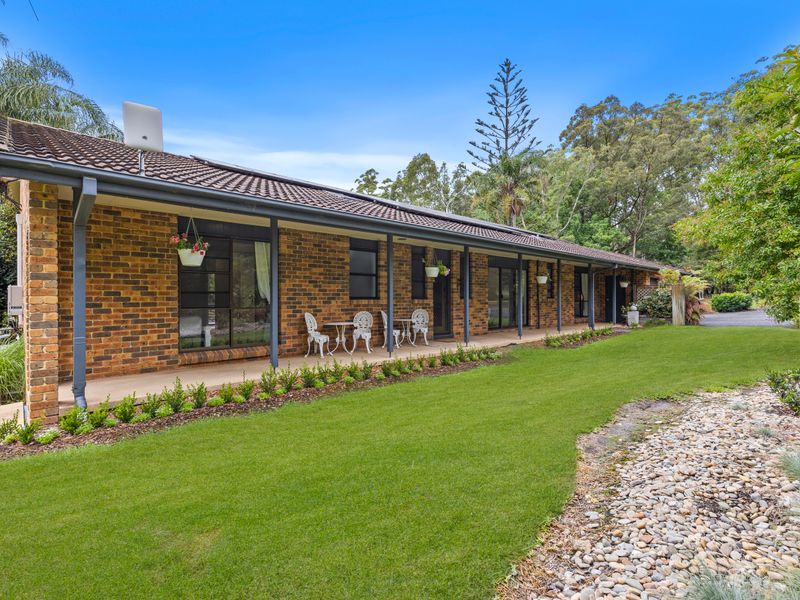 Charming exterior surrounded by lush greenery and lawns