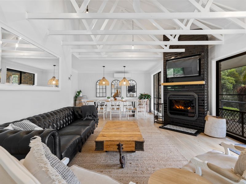 Light-filled open living area with cosy lounge and fireplace