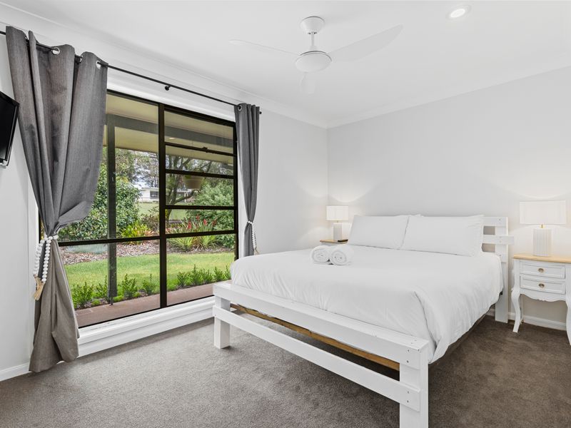 Serene bedroom with plush bedding and garden views