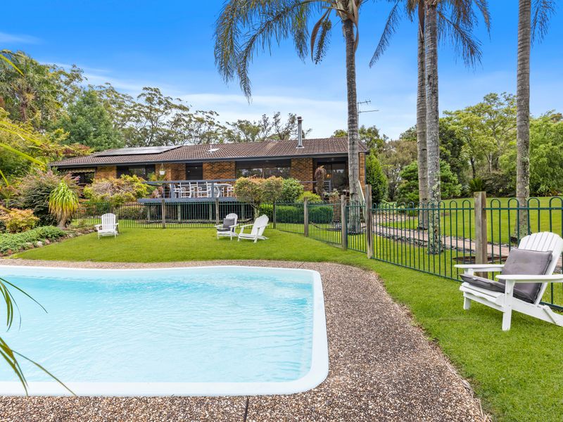 Sparkling swimming pool set within lush tropical gardens