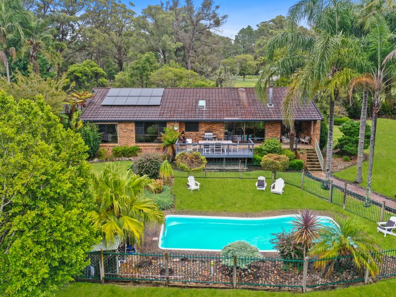 Elevated aerial view of the home with pool and lawn areas