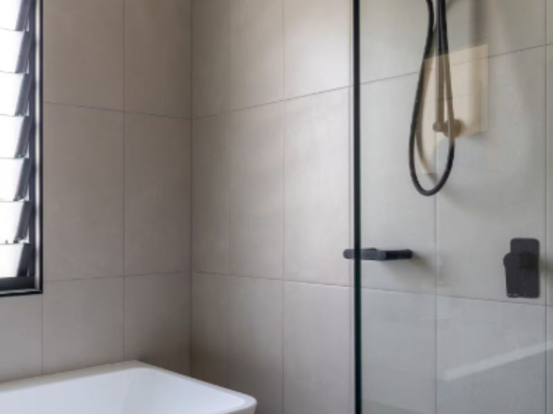 Shower area with contemporary fixtures and tiled walls