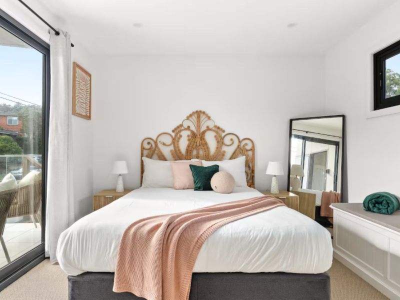 Bright bedroom with elegant headboard and soft tones