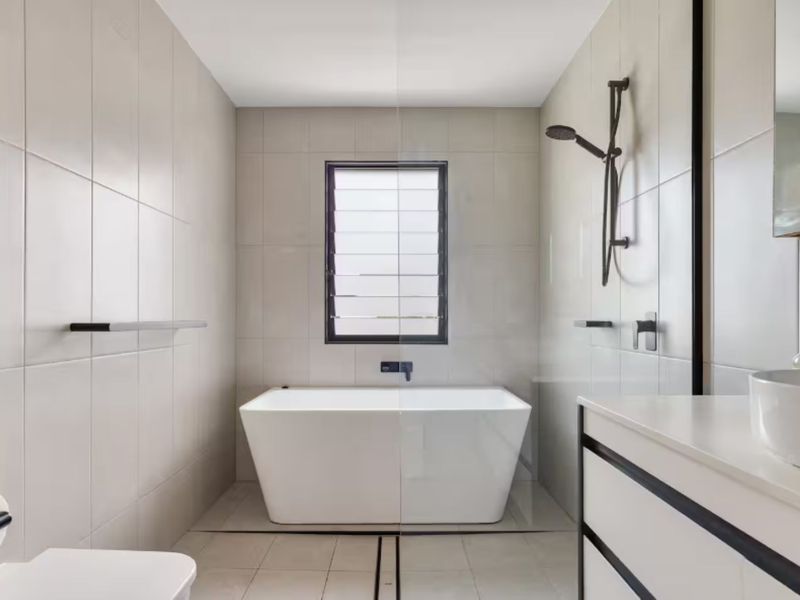 Bathroom with freestanding bathtub and bright finish