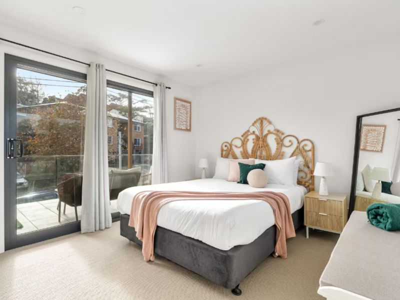 Spacious master bedroom with balcony access