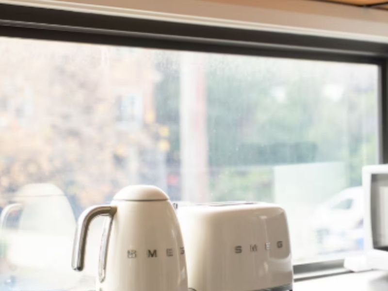 Toaster and kettle setup by the kitchen window