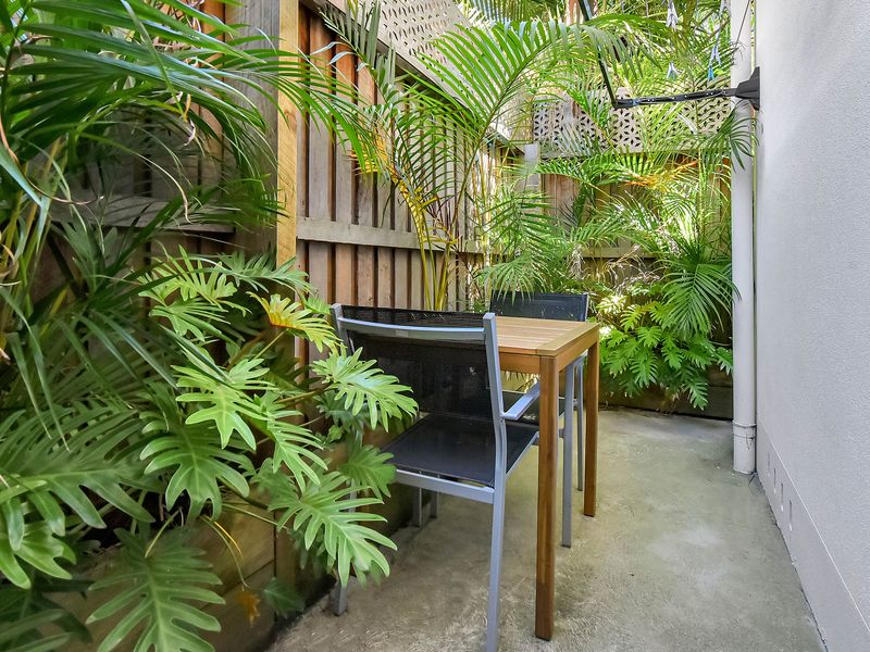 Private courtyard with lush greenery and seating