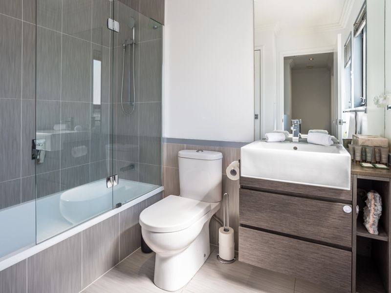 Bathroom featuring a bathtub, shower, and modern fittings.