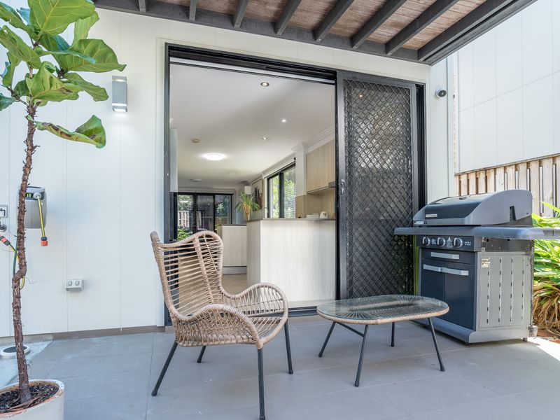 Covered patio with outdoor seating and direct indoor access.