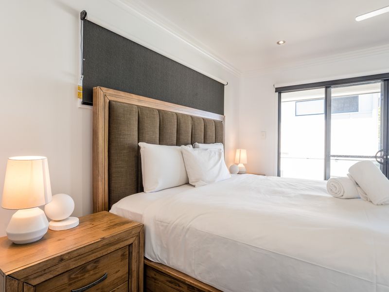 Bedroom with king bed and large window for natural light.