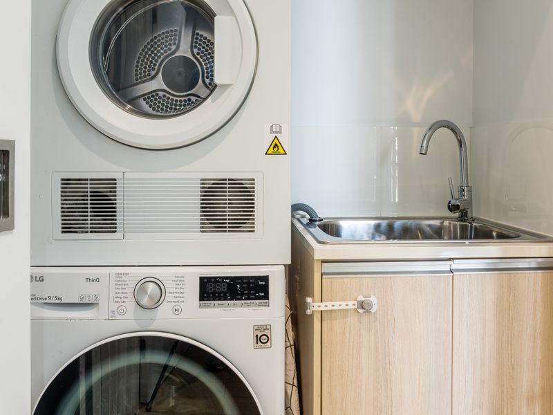 Laundry area with washer, dryer, and sink.