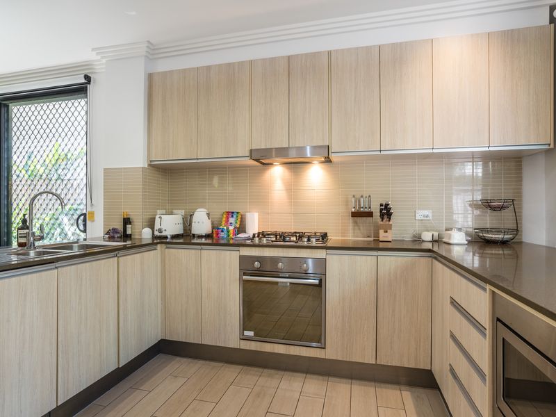 Full kitchen with gas cooktop, oven, and modern cabinetry.