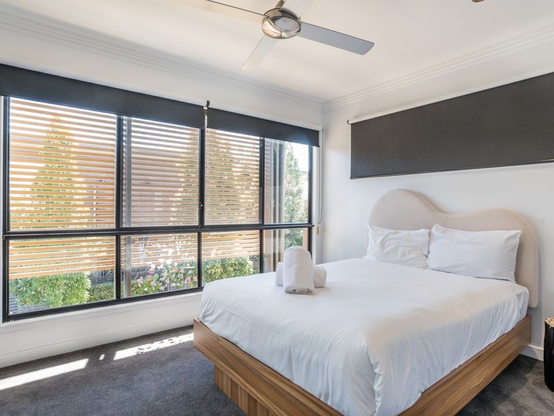 Bedroom with double bed and blackout blinds.
