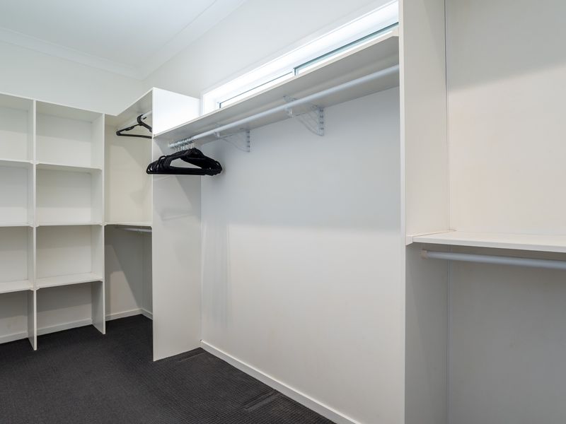 Spacious walk-in closet with built-in shelving.