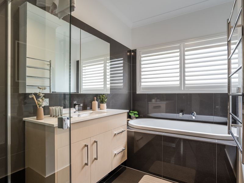 Elegant bathroom with full-size bathtub and glass shower.
