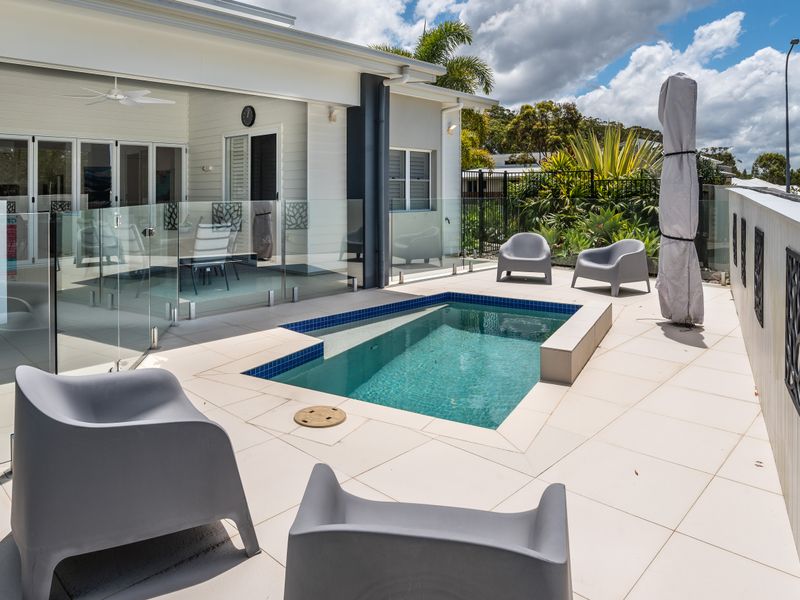Relax by the sparkling private pool in a serene setting.